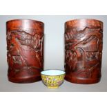 A PAIR OF EARLY 20TH CENTURY CHINESE CARVED BAMBOO BRUSH POTS, each decorated with a scene of sages,