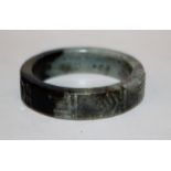 ANOTHER UNUSUAL CHINESE JADE BANGLE, 19th Century or earlier, the stone of predominantly grey-