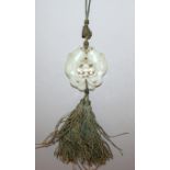 A GOOD QUALITY 19TH CENTURY CHINESE PALE CELADON JADE PENDANT, with attached tassels, well carved