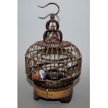 A SMALL 20TH CENTURY CHINESE BAMBOO BIRD CAGE, fitted to its interior with three blue and white