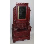 AN EARLY 20TH CENTURY CHINESE RED STAINED CARVED WOOD MIRROR CABINET, the removable mirror supported