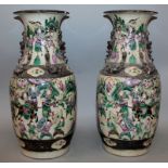 A PAIR OF CHINESE FAMILLE ROSE CRACKLEGLAZE PORCELAIN VASES, circa 1900, each painted with scenes of