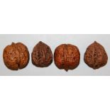 A GROUP OF FOUR LION’S HEAD WALNUTS, the largest 1.6in x 1.5in. (4)