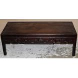 A CHINESE CARVED DARK HARDWOOD LOW RECTANGULAR TABLE, the frieze carved in relief with leafy vine