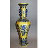 A LARGE CHINESE YELLOW GROUND PORCELAIN VASE, the slender hexagonal-section body decorated with