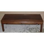 A CHINESE CARVED LIGHT HARDWOOD LOW RECTANGULAR TABLE, the frieze carved in relief with a simple