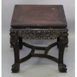 A 19TH/20TH CENTURY CHINESE CARVED HARDWOOD LOW SQUARE-SECTION STAND, with linked stretcher