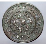 A SMALLER CHINESE TANG-STYLE SILVERED BRONZE MIRROR, the interior decorated within a raised rim with