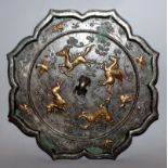 A GOOD QUALITY LARGE CHINESE TANG-STYLE SILVERED AND GILDED EIGHT PETAL BRONZE MIRROR, decorated
