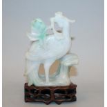 A GOOD 19TH CENTURY CHINESE CARVED JADEITE MODEL OF A PHOENIX, together with a fitted wood stand,