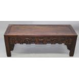 A 20TH CENTURY CHINESE CARVED LOW RECTANGULAR TABLE, with three drawers, the sides carved with