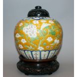 A 19TH CENTURY CHINESE YELLOW GROUND PORCELAIN JAR, together with a good quality carved hardwood