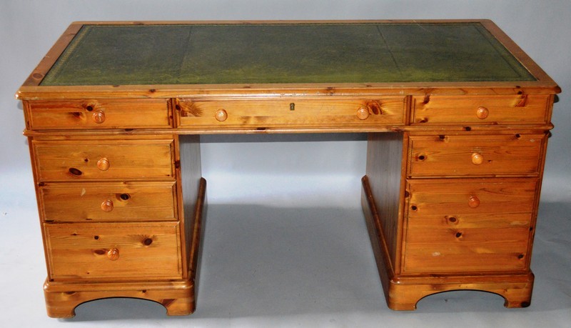 A GOOD PINE RECTANGULAR TOP PEDESTAL DESK with inset leather top, three frieze drawers, drawers to