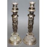 A PAIR OF PLATE “EGYPTIAN FIGURE” AND ROCK CRYSTAL CANDLESTICKS on circular bases 10ins high.