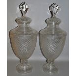 A LARGE PAIR OF CUT GLASS URN SHAPED VASES AND COVERS 25ins high.