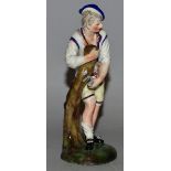 AN 18TH CENTURY LUDWIGSBURG FIGURE OF A GARDENER sharpening his sickle, interlaced double C mark