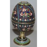 A RARE RUSSIAN SILVER AND ENAMEL EGG which when open forms a pair of eggcups with screw on bases.