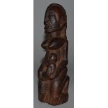 AN AFRICAN CARVED WOOD TRIBAL FIGURE, a woman holding a baby 6.5ins high.