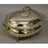 AN ASPREY & CO OVAL SOUP TUREEN AND COVER, gadrooned edge with shells on claw feet. 13ins long.