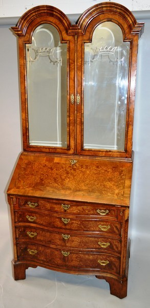 A GEORGE I DESIGN WALNUT DOUBLE DOME TOP BUREAU CABINET, the moulded top over a pair of mirrored