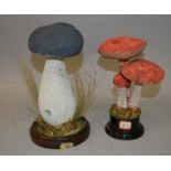 TWO MUSHROOM GROUPS, SPECIMENS of one and three mushrooms on wooden stands 9.5ins high and 8.5ins