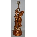 A LARGE AMERICAN GILT METAL FIGURAL LAMP as a classical female figure standing beside a column on