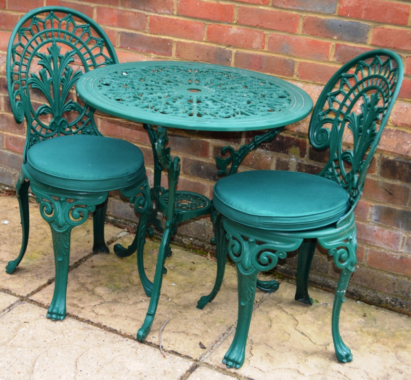 A PAIR OF GREEN PAINTED CAST ALUMINIUM SMALL PATIO TABLES; together with six chairs, two