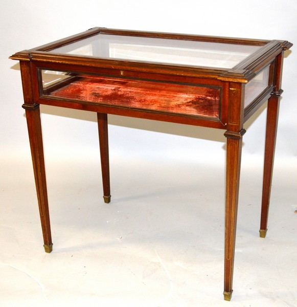 A GOOD MAHOGANY AND BRASS LINE INLAID BIJOUTERIE TABLE, the rectangular top with extended corners,