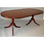 A GEORGIAN STYLE MAHOGANY DOUBLE PILLAR DINING TABLE with loose leaf. 7ft 2ins long.