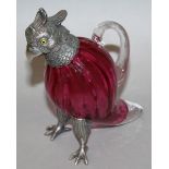 A SMALL CRANBERRY GLASS PARAKEET CLARET JUG with plated head and feet 6.5ins high.