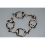 A STERLING SILVER HALLMARKED “SNAFFLE” BRACELET 7ins long.