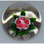 A BACCARAT PANSY PAPERWEIGHT with single pink and white pansy with green leaves and star cut base.