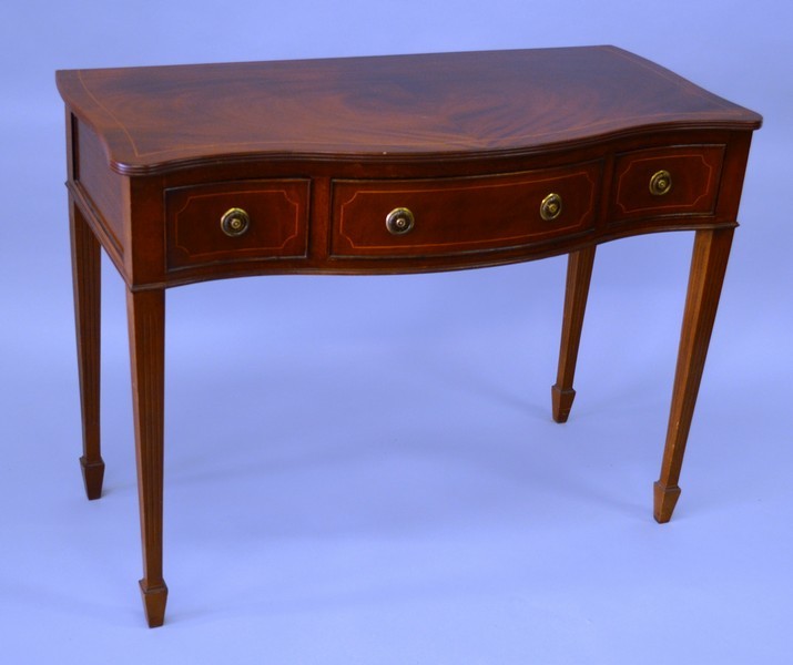 A PAIR OF GEORGIAN MAHOGANY SERPENTINE FRONTED SIDE TABLES, both with three frieze drawers, one