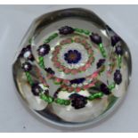 A GOOD FACET CUT HEXAGONAL PAPERWEIGHT, Possibly BACCARAT, with bands of coloured canes and flower