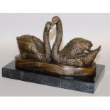 MILO A BRONZE GROUP, PAIR OF SWANS. Signed 7ins long, on a marble base.