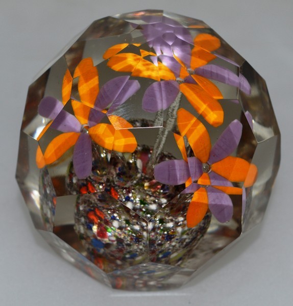 A FACET CUT NINE SIDED FLOWER PAPERWEIGHT. 2.75ins diameter.