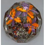 A FACET CUT NINE SIDED FLOWER PAPERWEIGHT. 2.75ins diameter.