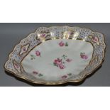 AN 18TH CENTURY DERBY NAVETTE SHAPED PEDESTAL DISH painted with roses and a large gilt border,