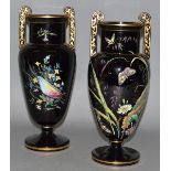 A GOOD PAIR OF VICTORIAN BLACK GLASS TWO HANDLED URNS painted with flowers and shells 12.5ins high.