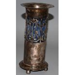 AN ART NOUVEAU PLATED PIERCED CYLINDRICAL VASE with glass liner on bun feet 7ins high Maker: J.