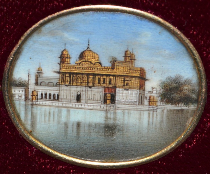 A SET OF FOUR SMALL INDIAN OVAL MINIATURES OF BUILDINGS, 1in wide, reframed in gilt and velvet