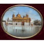 A SET OF FOUR SMALL INDIAN OVAL MINIATURES OF BUILDINGS, 1in wide, reframed in gilt and velvet