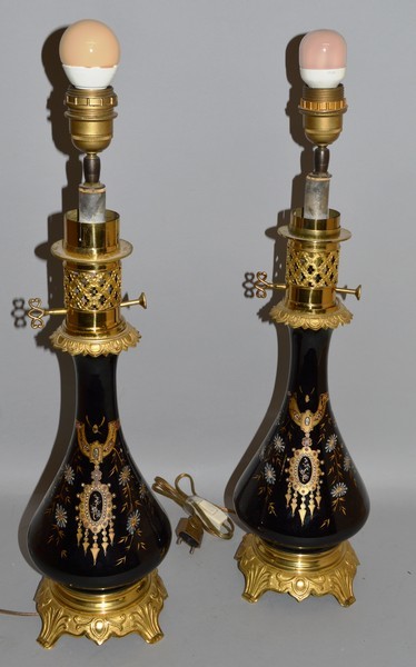 A PAIR OF VICTORIAN BLACK GLASS LAMPS with ormolu mounts and bases 24ins high.