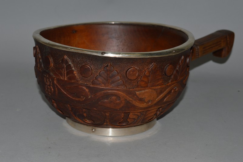 A 19TH CENTURY, POSSIBLY SCOTTISH, CARVED WOOD LADLE, 8ins diameter, with silver mounts, London