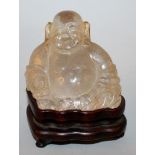 A 19TH/20TH CENTURY CHINESE ROCK CRYSTAL CARVING OF BUDAI, together with a fitted wood stand, the