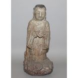 AN UNUSUAL CHINESE CARVED STONE FIGURE OF A BODHISATTVA, possibly early, rendered standing on a