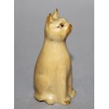 A SMALL EARLY 20TH CENTURY JAPANESE IVORY CARVING OF A SEATED CAT, 2.1in high.