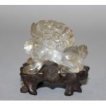 A SMALL EARLY 20TH CENTURY CHINESE ROCK CRYSTAL CARVING OF A BUDDHISTIC LION, together with a fitted