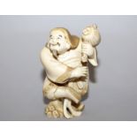 A 19TH/20TH CENTURY SIGNED JAPANESE IVORY FIGURE OF DAIKOKU, standing with one foot raised and