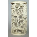 AN EARLY 20TH CENTURY CHINESE CARVED IVORY TUSK VASE, carved in high relief with buildings and